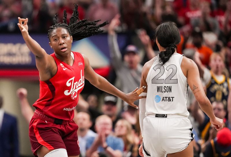 Indiana Fever center Aliyah Boston (7) celebrates a three-point basket on against Las Vegas Aces center A'ja Wilson (22) on Thursday, Aug. 6, 2026, during the game at Gainbridge Fieldhouse in Indianapolis.