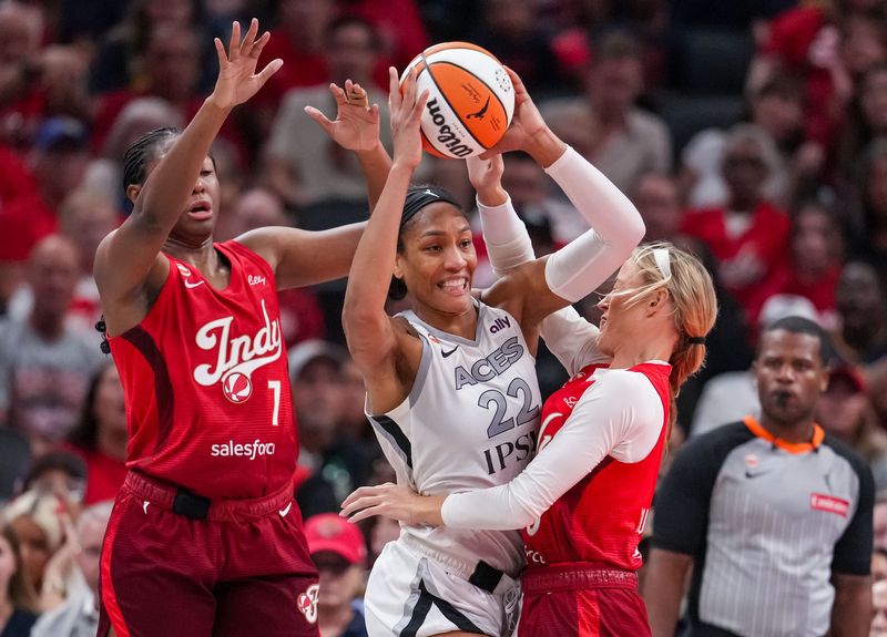 Las Vegas Aces center A'ja Wilson (22) passes the ball against Indiana Fever guard Sophie Cunningham (8) on Thursday, Aug. 6, 2026, during the game at Gainbridge Fieldhouse in Indianapolis. The Las Vegas Aces defeated the Indiana Fever in overtime, 86-84.