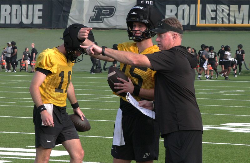Purdue quarterbacks coach Darin Hinshaw and quarterback Ryan Browne (15) discuss routes during practice at Kozuch Football Performance Complex on Aug. 6, 2026 in West Lafayette, Indiana.