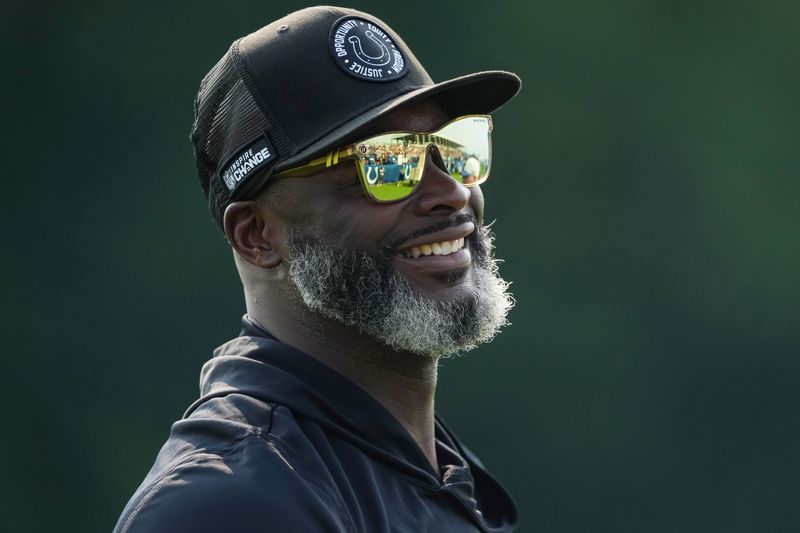 Indianapolis Colts wide receiver coach Reggie Wayne smiles as fans yell his name on Sunday, Aug. 9, 2026, during Colts Camp practice at Gand Park in Westfield.