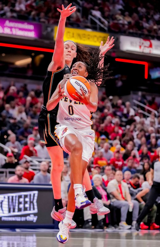 Indiana Fever guard Kelsey Mitchell (0) goes in for a lay-up against New York Liberty forward Breanna Stewart (30) on Tuesday, Aug. 11, 2026, during the game at Gainbridge Fieldhouse in Indianapolis.