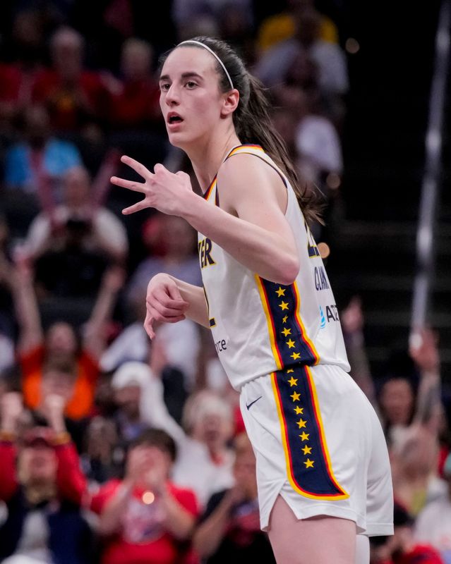 Indiana Fever guard Caitlin Clark (22) holds up three fingers after scoring a three-point basket on Tuesday, Aug. 11, 2026, during the game at Gainbridge Fieldhouse in Indianapolis.