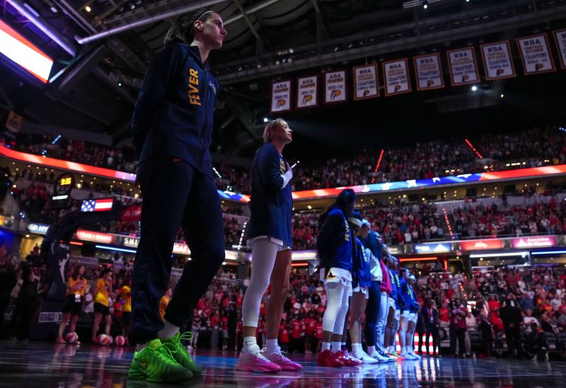 Indiana Fever guard Caitlin Clark (22) stands for the national anthem on Tuesday, Aug. 11, 2026, during the game at Gainbridge Fieldhouse in Indianapolis.