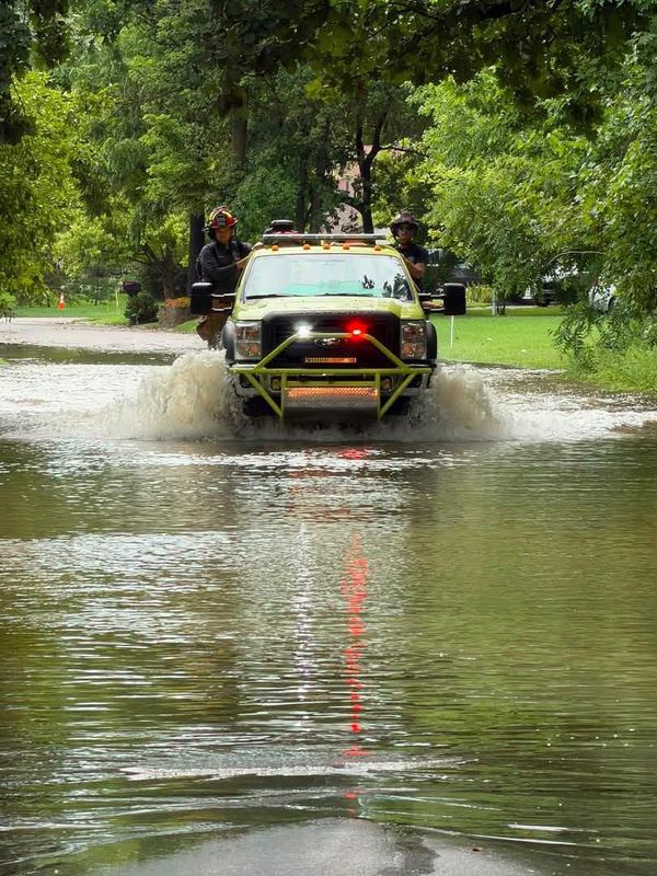 Muncie firefighters on Wednesday checked on the well-being of residents in flooded neighborhoods, helping some evacuate - in some instances using boats - and go to a place of safety.