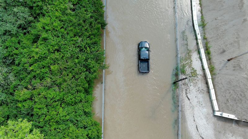 A pickup truck sits in flood waters Thursday, Aug. 13, 2026, on West Cornbread Road in Muncie.