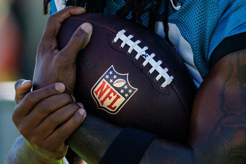 Aug 13, 2026; Metairie, LA, USA;  Detailed view of the NFL logo on the football during a joint scrimmage between the New Orleans Saints and the Jacksonville Jaguars during at Ochsner Sports Performance Center. Mandatory Credit: Stephen Lew-Imagn Images