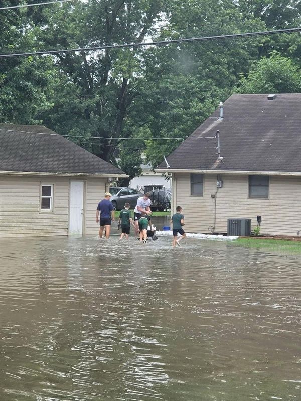 The Pendleton Heights football team helped neighbors in the community on Thursday who experienced flooding damage.