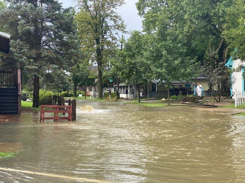 Water gushing through a storm drain at the intersection of Cornell Ave and Coil St