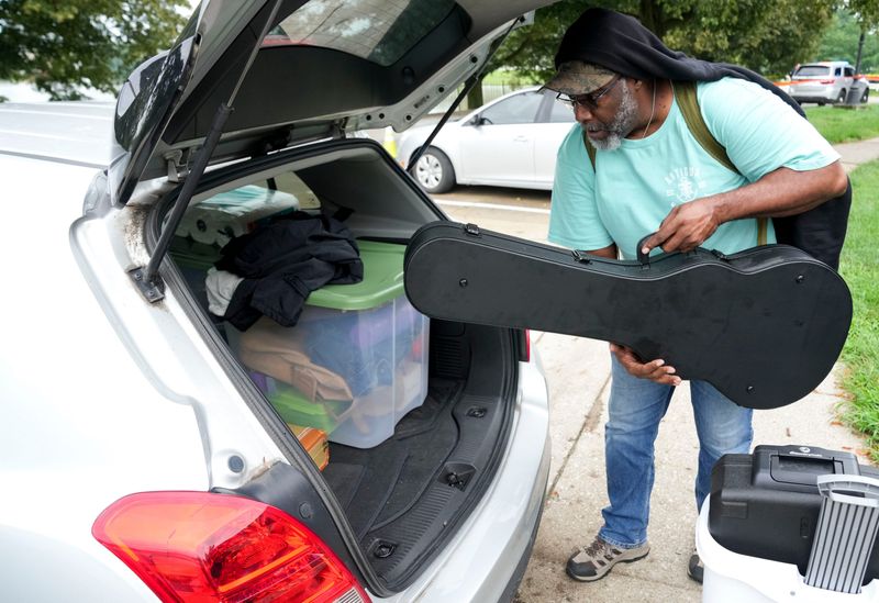 Tucker Parker loads items from his apartment into a car after it was evacuated due to imminent structure failure related to the flood on Sunday, Aug. 16, 2026, at the River Roads on Indianapolis’ north side. Parker left Saturday morning and returned Sunday to get items from his home before leaving again.