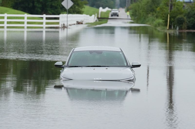A car sits in floodwater along the intersection of North Smokey Row Road and Indiana State Road 144 on Monday, Aug. 17, 2026, in Morgan County.