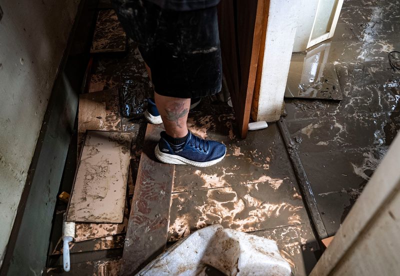 Steve Staton walks through his home Sunday, Aug. 16, 2026, at Riverwood in Noblesville. After waking to the sound of their dog splashing through rising floodwaters around their bed, Staton and his wife, Laura Sewell, evacuated the home where they had lived for 28 years.