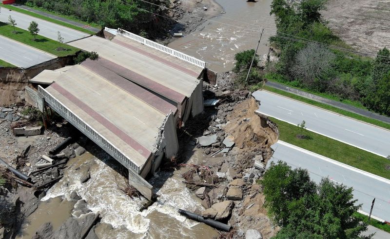 A bridge on Hazel Dell Parkway sits damaged after historic flooding Tuesday, Aug. 18, 2026, in Carmel.