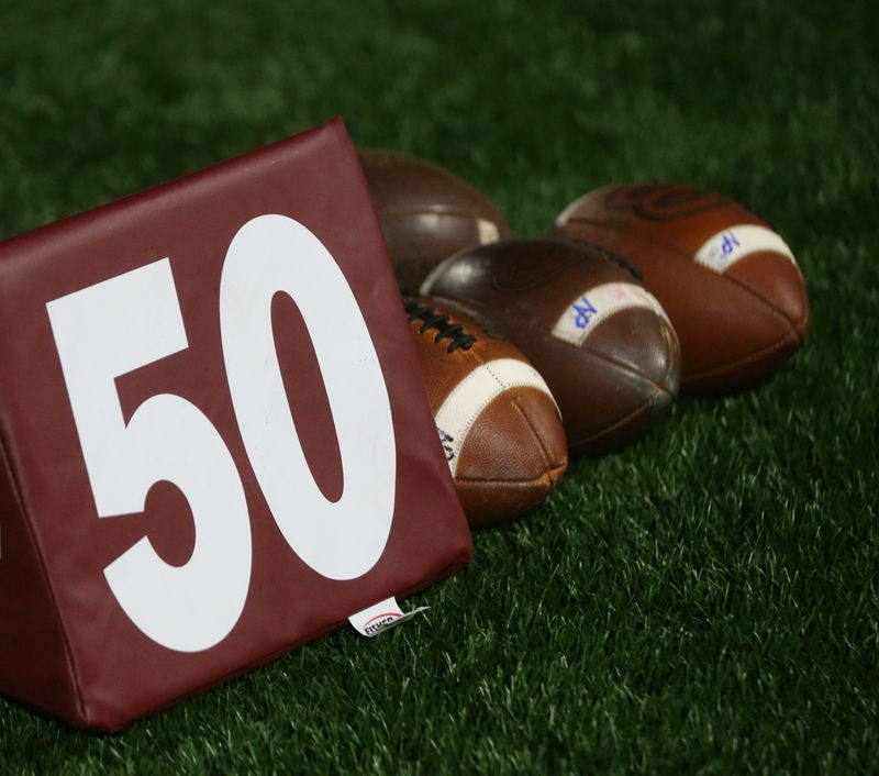 A 50-yard marker and footballs are pictured in this file photo.