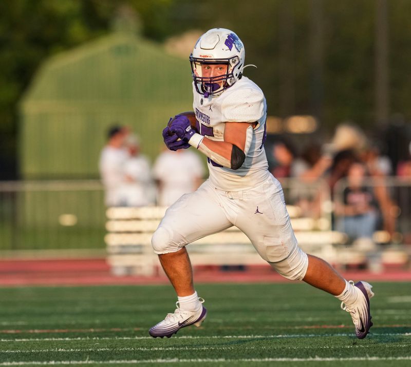 Brownsburg Bulldogs Brady Lewis (25) runs the ball Friday, Aug. 21, 2026, during a game at Lawrence North High School in Indianapolis.