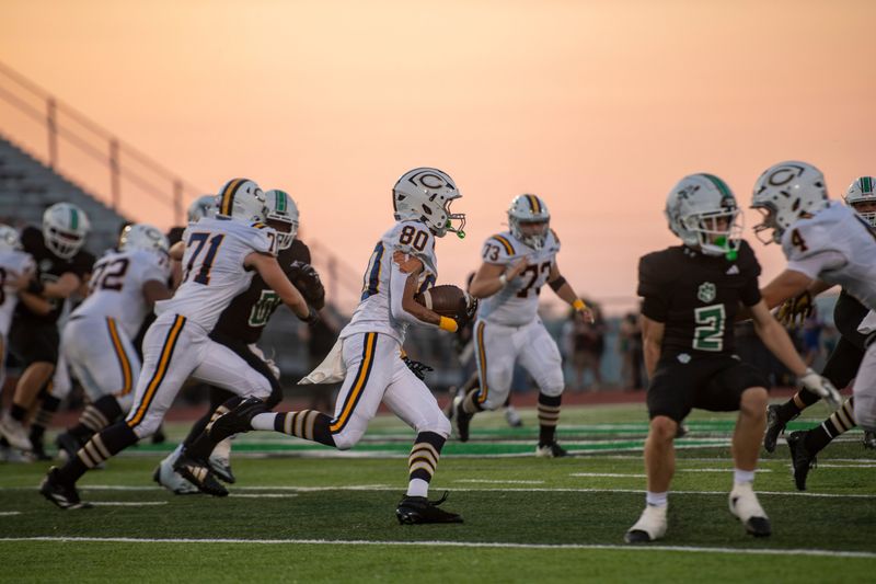 Castle's Benjamin Quach (80) carries the ball as the North Huskies play the Castle Knights at Bundrant Stadium in Evansville, Ind., Friday. August 21, 2026.