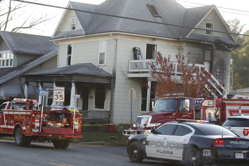 Crews investigate an early morning fire in Flora that killed four children and injured two police officers on Nov. 21, 2016.