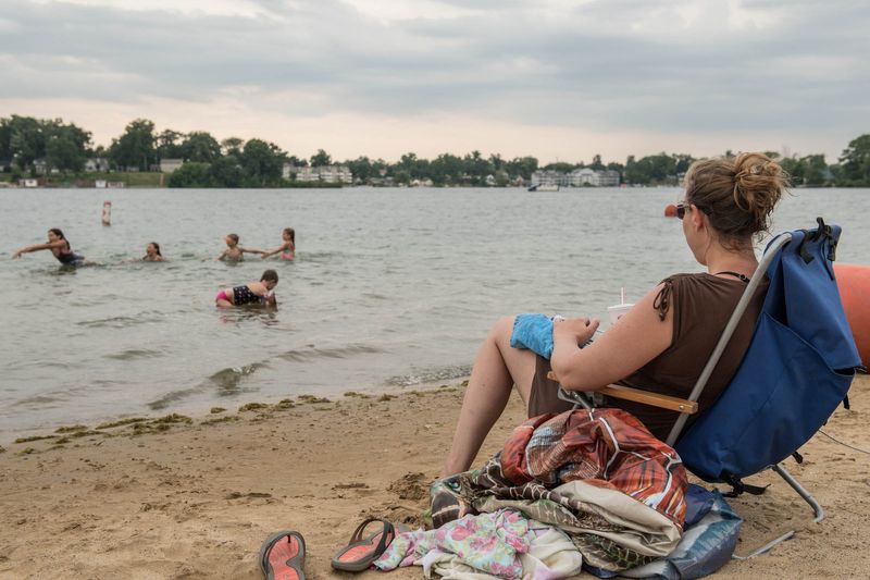In this June 2016 photo, Marci Andrews from East Leroy relaxes at Willard Beach while keeping an eye on some of her kids enjoying the water.