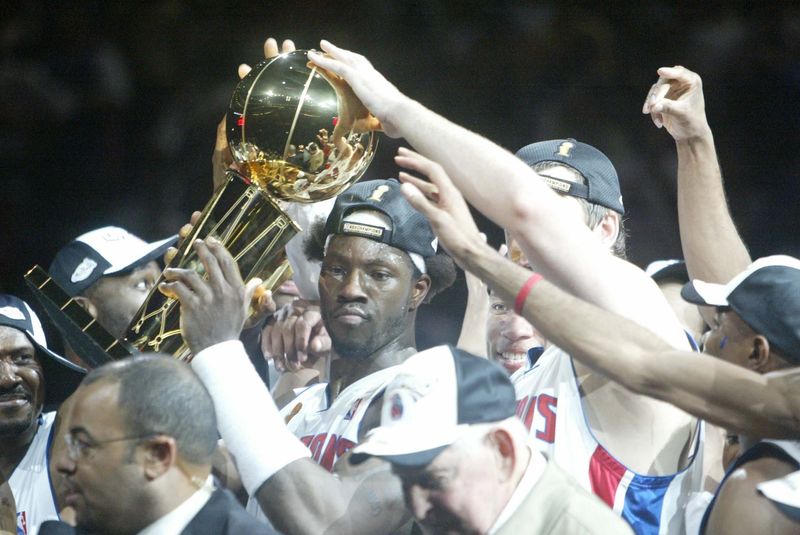 Detroit's Ben Wallace and teammates hold up the Larry O'Brien trophy after the Pistons defeated the Lakers 100-87 in Game 5 of the NBA Finals, Tuesday, June 15, 2004 at the Palace of Auburn Hills.