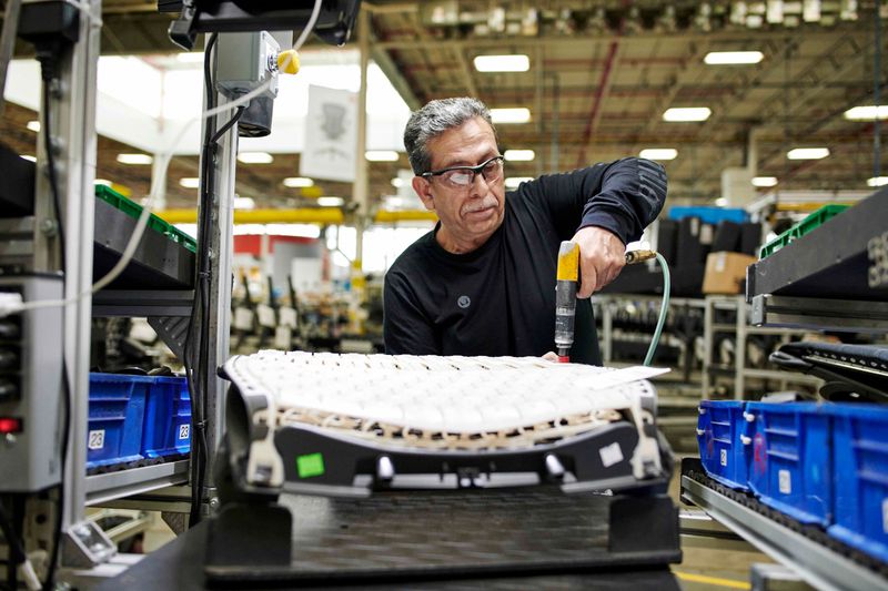 An employee works on the line at MillerKnoll, a global manufacturing company in Zeeland, Michigan.
