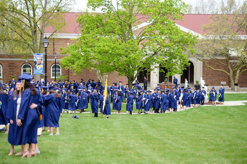 Siena Heights University students gather in Trinity Garden prior to commencement on May 6, 2023.