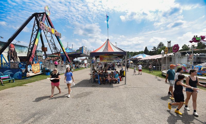 People cruise the midway Wednesday, Aug. 2, 2023, at the 169th Annual Ingham County Fair in Mason.