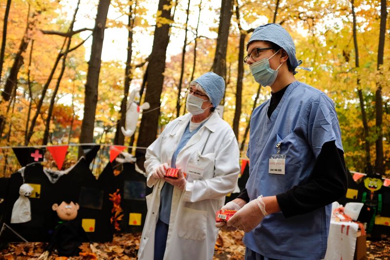 Betty Dunn and Zachary Dunn, of Port Huron, hand out candy during the Halloween Stroll Saturday, Oct. 25, 2014 at Sanborn Park in Port Huron.