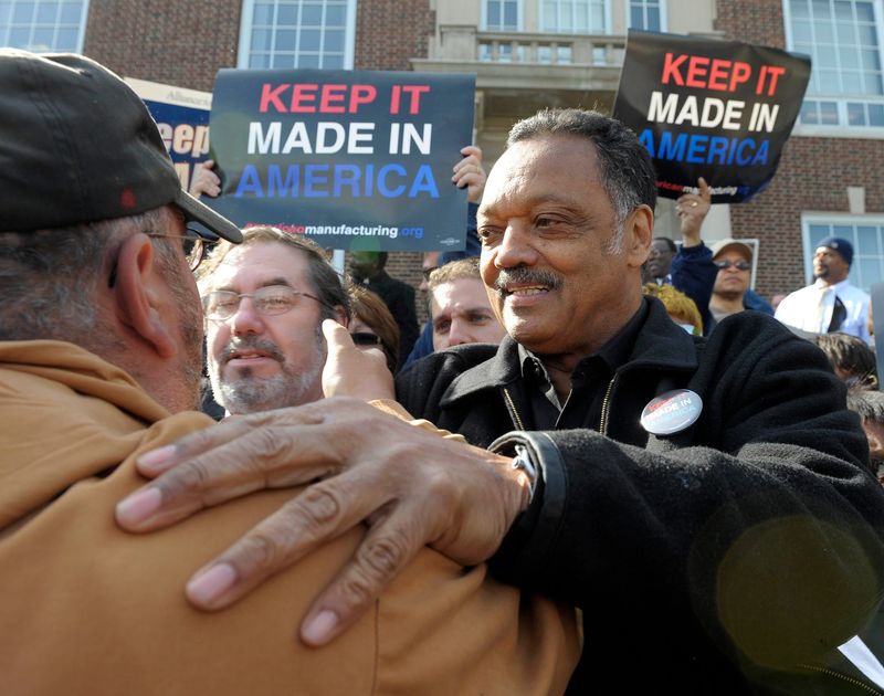 The Rev. Jesse Jackson hugs a union member in the crowd in front of Dearborn City Hall at a Made in the U.S.A. rally in 2014.
