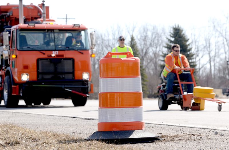 Orange barrels are on display on Holt Road in this March 2014 Lansing State Journal file photo.