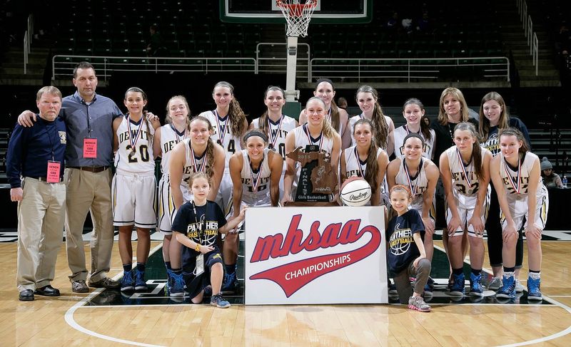 DeWitt players and coaches pose with their MHSAA Class A runner-up trophy Saturday, March 21, 2015, at the Breslin Center in East Lansing, Mich. DeWitt fell 51-37.