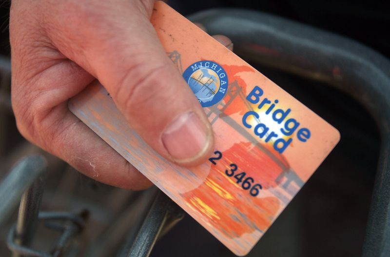 Laid-off automotive designer Michael Remenar (cq-al), 60, of Grosse Pointe Woods, Mich., shops for groceries with a food stamp card at Kroger in Grosse Pointe Woods, Mich., on Tuesday, April 22, 2008. Remenar is one of a record high number of Michiganders qualifying for food stamps because of the poor economy. "I never expected it to get this bad," said Remenar who has had the card since February. AMY LEANG/Detroit Free Press