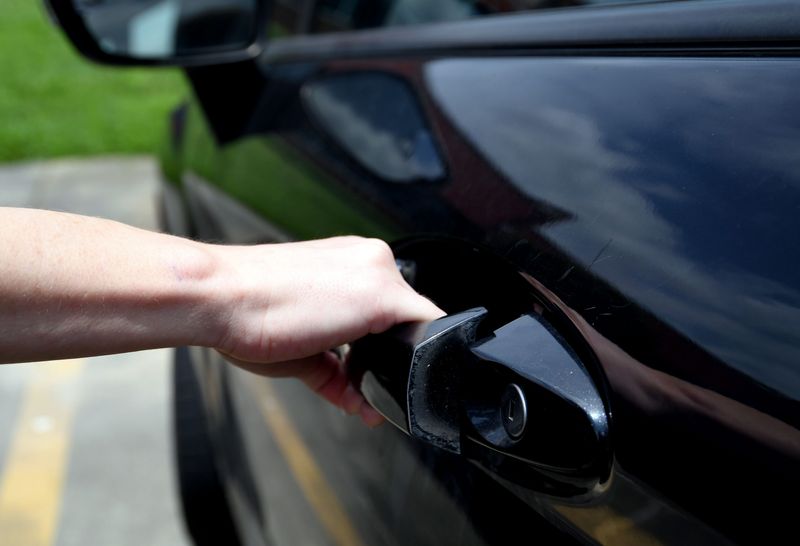 A photo illustration of a person pulling a car handle to see if the car is unlocked. The majority of vehicle owners who reported thefts left their car doors unlocked.