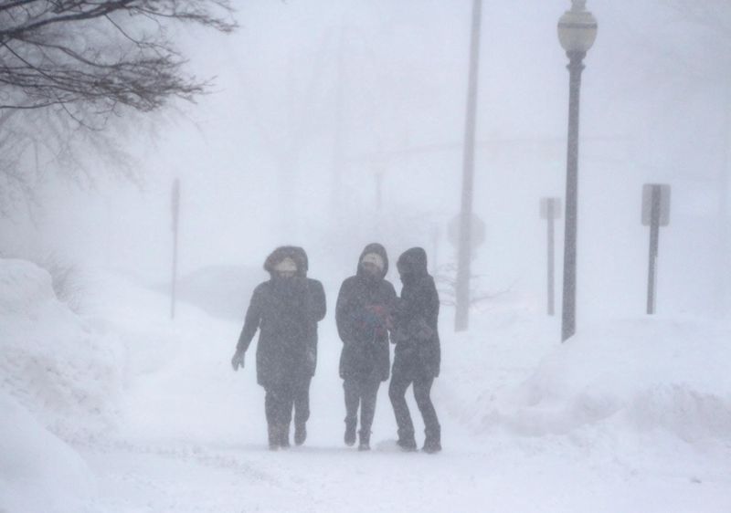 Students walk through a 2019 snowstorm on Hope College's campus. Snow, frigid temperatures and strong winds are predicted over the next few days as an Arctic front moves into Michigan.