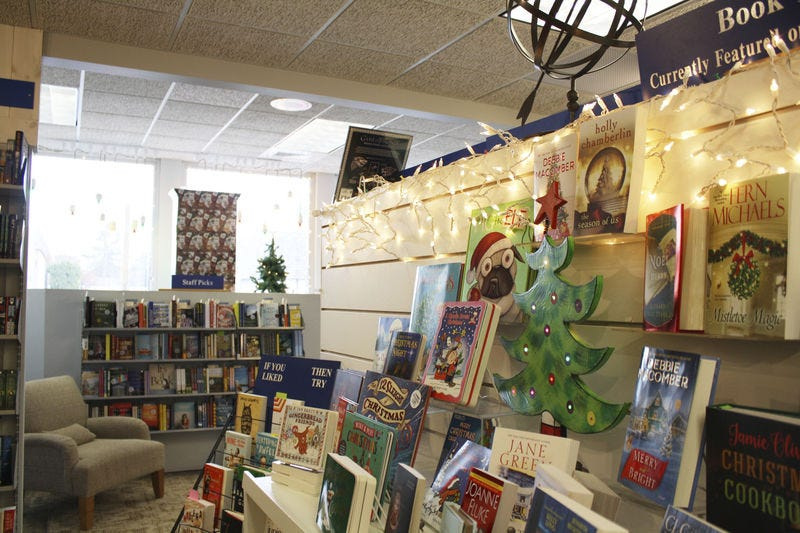 A Saturn Booksellers display shows holiday-themed children and adult books on sale during Black Friday in downtown Gaylord.