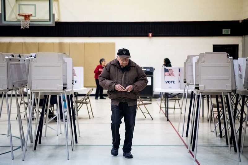 Bill Morris votes at Battle Creek First Assembly of God on Tuesday, March 10, 2020 in Battle Creek, Mich. Battle Creek voters are selecting presidential candidates and voting on two proposals, one that would change how the mayor is elected and one that would change the city charter to use ungendered language.