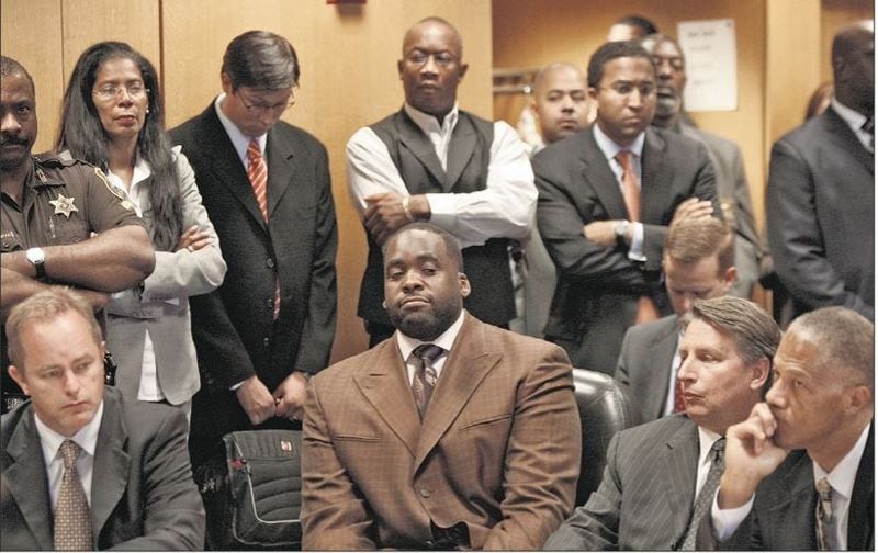 Former Detroit Mayor Kwame Kilpatrick, seen here surrounded by his attorneys as he prepared to plead guilty and resign from office, recently asked a federal judge to terminate any remaining restitution he may owe tied to federal convictions stemming from his public corruption scandal.