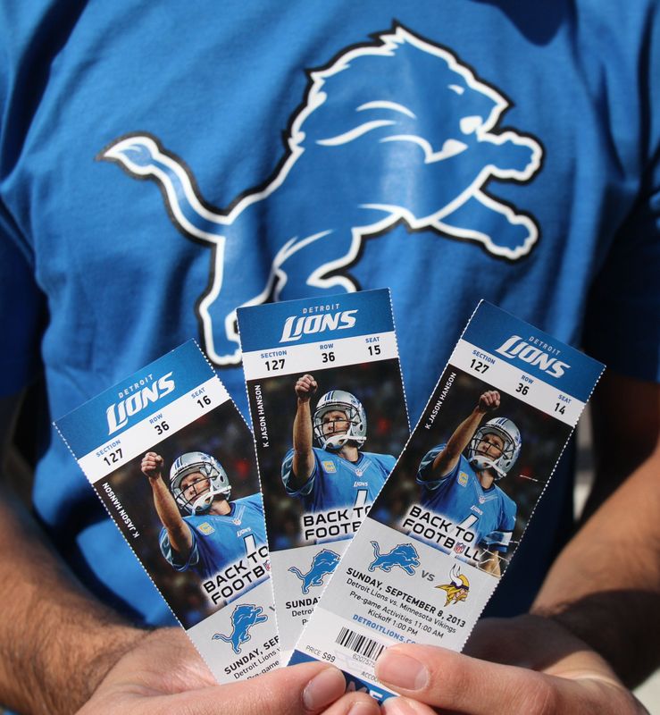 Detroit Lions fans hold their tickets before they enter Ford Field prior to the start of their home opener against the Minnesota Vikings, Sunday, Sept. 8, 2013.