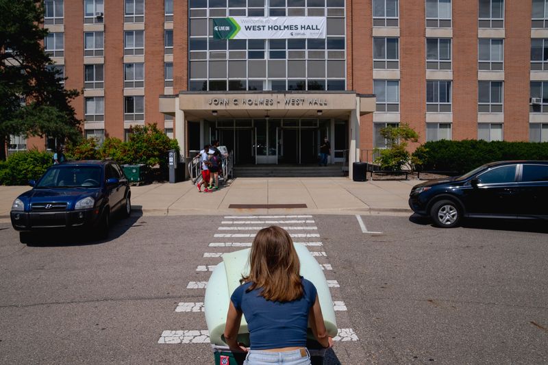 Incoming sophomore Charlotte Baude, 19, of Mundelein, Ill. helps her suite mate, Taylor Randolph of Clinton , 19, move in at West Holmes Hall at Michigan State University in East Lansing, Mich. on Aug. 22, 2023. (Nic Antaya, Special to The Detroit News)