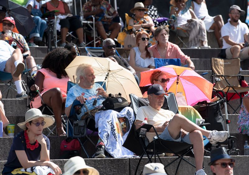 Music fans watch and listen to hometown artists Russ Miller: Beatitudes perform on the Carhartt Ampitheater Stage in Hart Plaza during the free 2023 Detroit Jazz Festival.