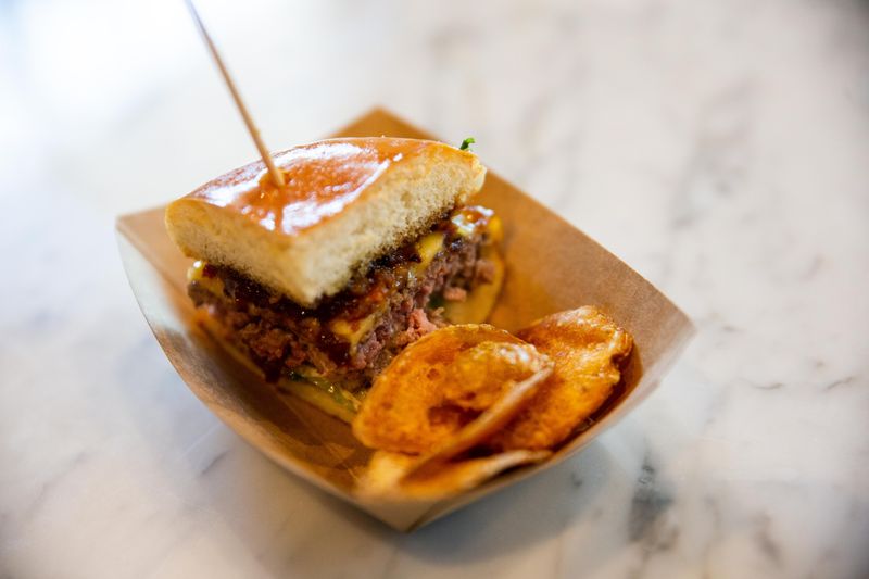 Goog's Brawler Burger featuring a blended brisket, chuck and short rib patty, smoked gouda cheese, bacon jam and bacon aioli.