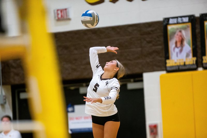 East's Jordan Inosencio serves the ball during a game against West Thursday, Sept. 14, 2023, at Zeeland East.