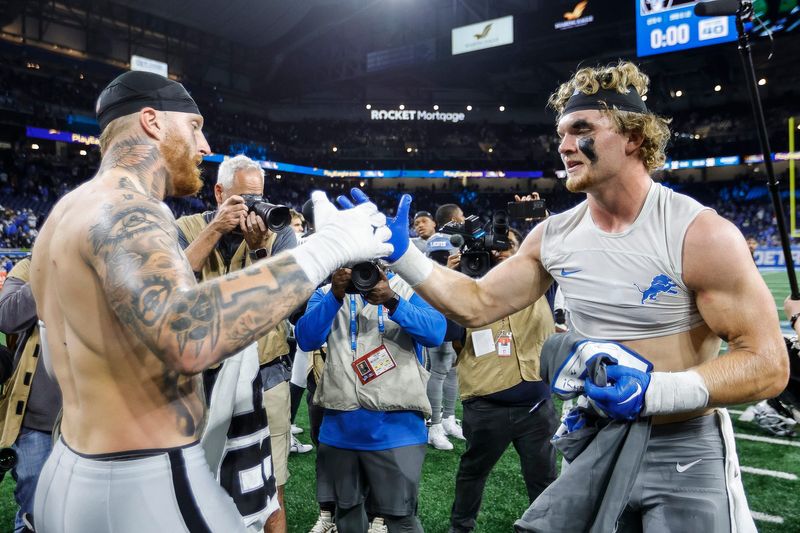 Detroit Lions defensive end Aidan Hutchinson, right, and Las Vegas Raiders defensive end Maxx Crosby exchange jerseys after the Lions' 26-14 win at Ford Field in Detroit on Monday, Oct. 30, 2023.
