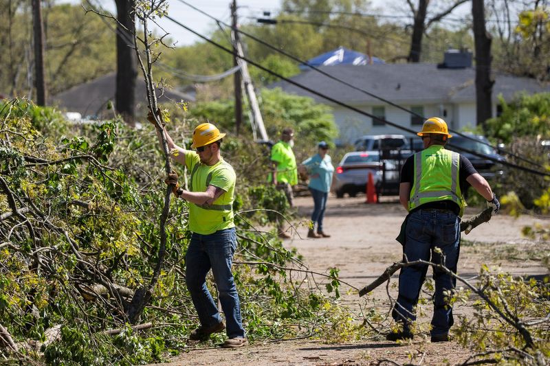 Consumer Energy crew members clean up tornado damage on Julie Drive in Portage on Wednesday, May 8, 2024.