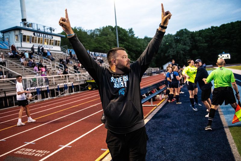 Livonia Stevenson coach Ken Shingledecker celebrates winning the Kensington Lakes Activities Association girls soccer championship on Thursday, May 16, 2024.