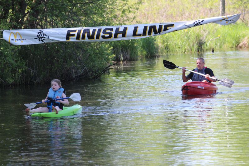 Kayakers make their way across the finish line Saturday, May 18, 2024, during Jonesville's RiverFest.