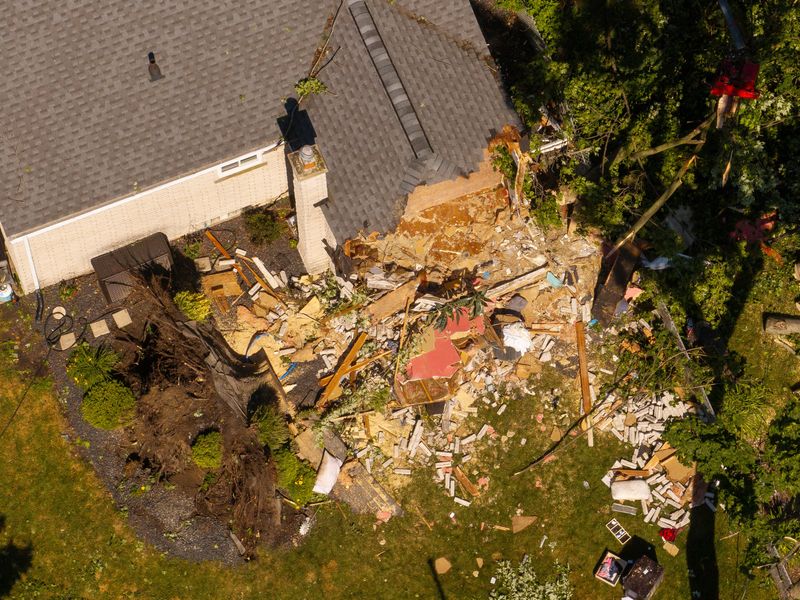Powerful storms the night before left this house damaged and trees destroyed on Houghton Street in Livonia. This is the scene on Thursday morning, June 6, 2024.
