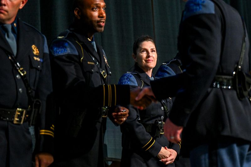 Michigan State Police Chief Deputy Director Lt. Col. Aimee Brimacombe, center, looks on as recruits are congratulated by Director Col. James Grady, left, during a graduation ceremony for the 145th Trooper Recruit School on Friday, June 7, 2024, at the Lansing Center in downtown Lansing.