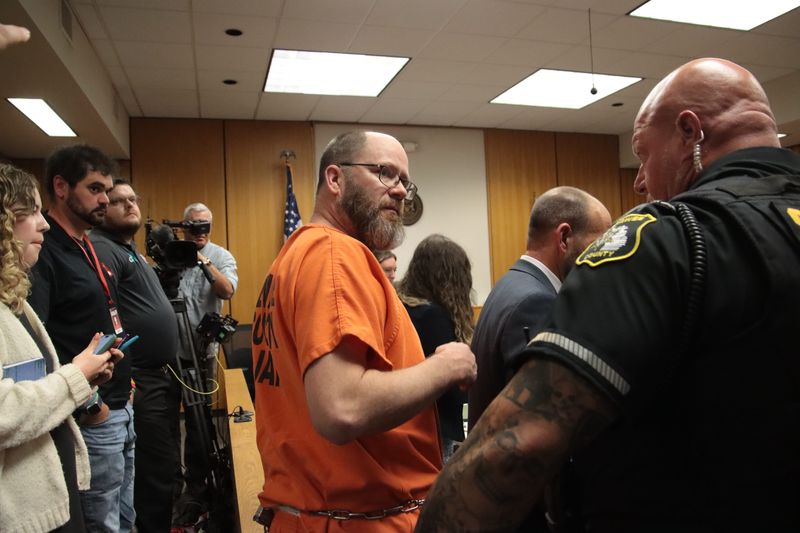 Dale Warner, center, is returned to the Lenawee County Jail following a preliminary exam in 2024.