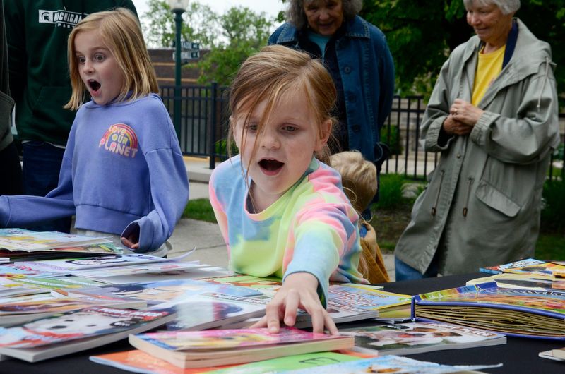 Brecklyn Bailey, 5, of Grand Rapids picks out a free book at the Petoskey District Library's summer reading launch event on Friday, June 7, 2024.