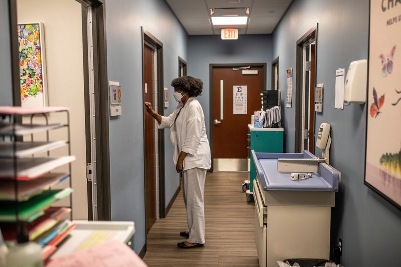 Clinical Social Worker Beverly Weathington, 64, of St. Clair Shores, knocks on the door of an exam room to meet with a patient at the Wayne State Pediatrics Early Childhood Support Clinic, that integrates routine pediatric care and behavioral health for parents and young children in an effort to address maternal and infant mental health in the same space on Monday, May 20, 2024. 

Despite the fact that around one in five new mothers may experience a perinatal mood and anxiety disorder, barriers including stigma prevent many women from getting diagnosed and treated. Poor maternal mental health has proven negative health effects for babies and toddlers.