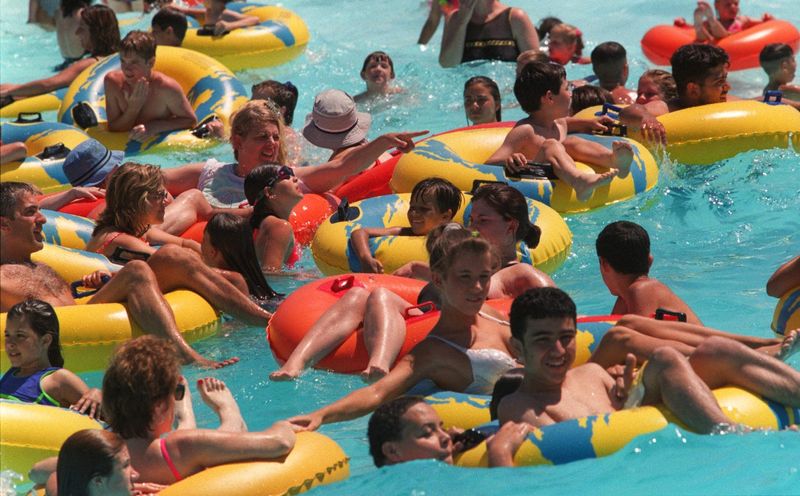 Floating in a sea of humanity, visitors to the Red Oaks Waterpark in Oakland County on 13 Mile Rd. cool off in the wave pool on June 22, 1998, as temperatures climbed into the 90s in the metro area.